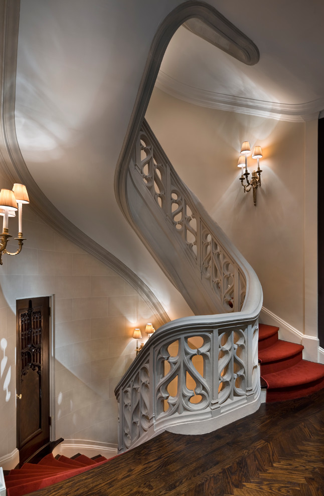 Photo of an expansive traditional carpeted spiral staircase in New York with wood risers.