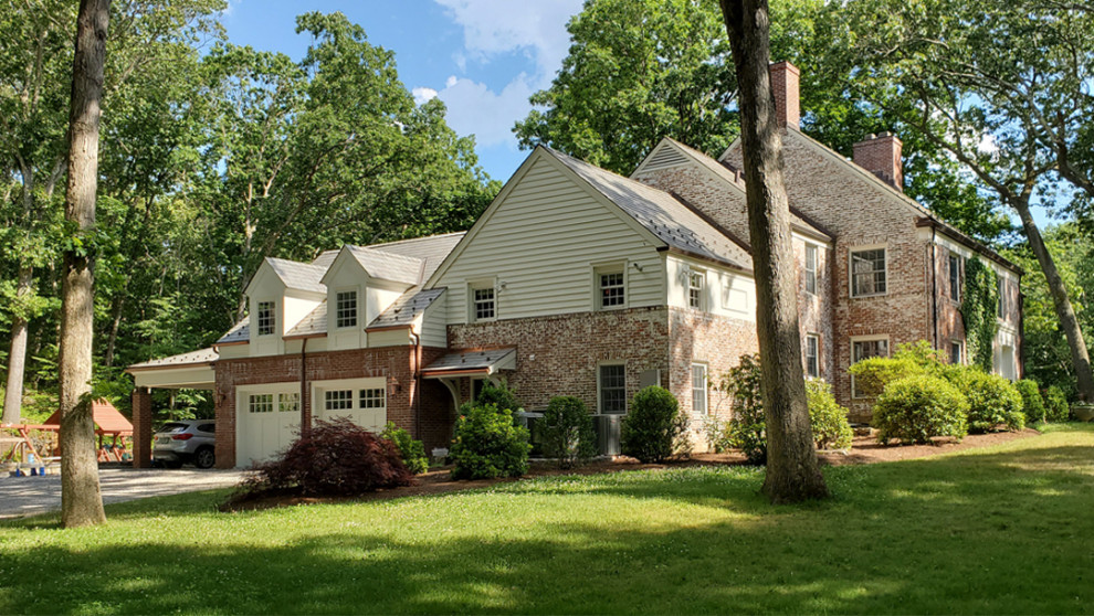 Inspiration for a mid-sized timeless attached one-car carport remodel in New York