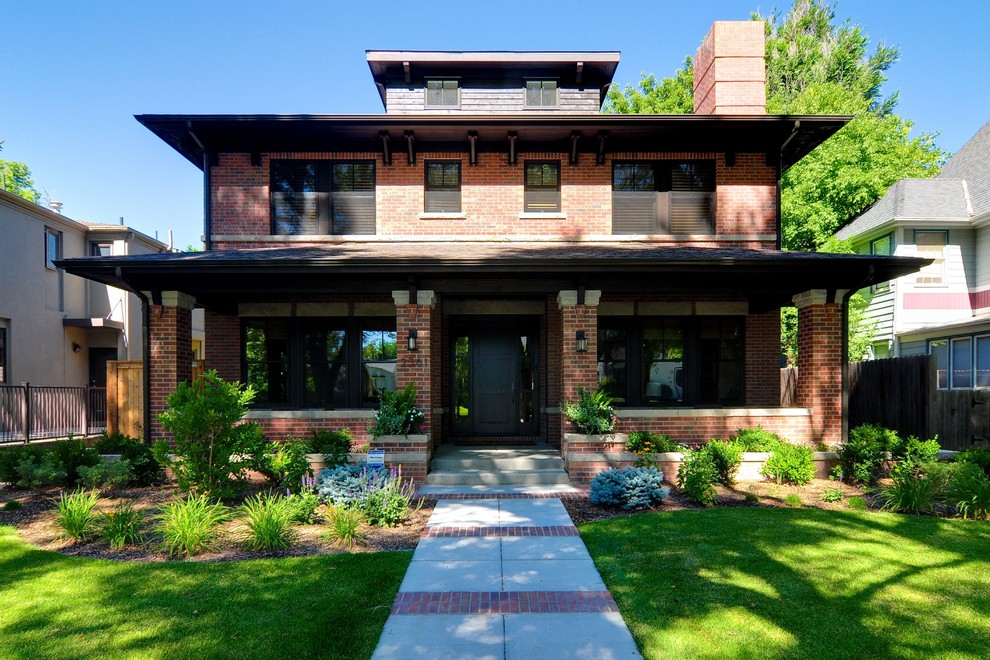 Photo of a large traditional three-storey brick red house exterior in Denver with a shingle roof.