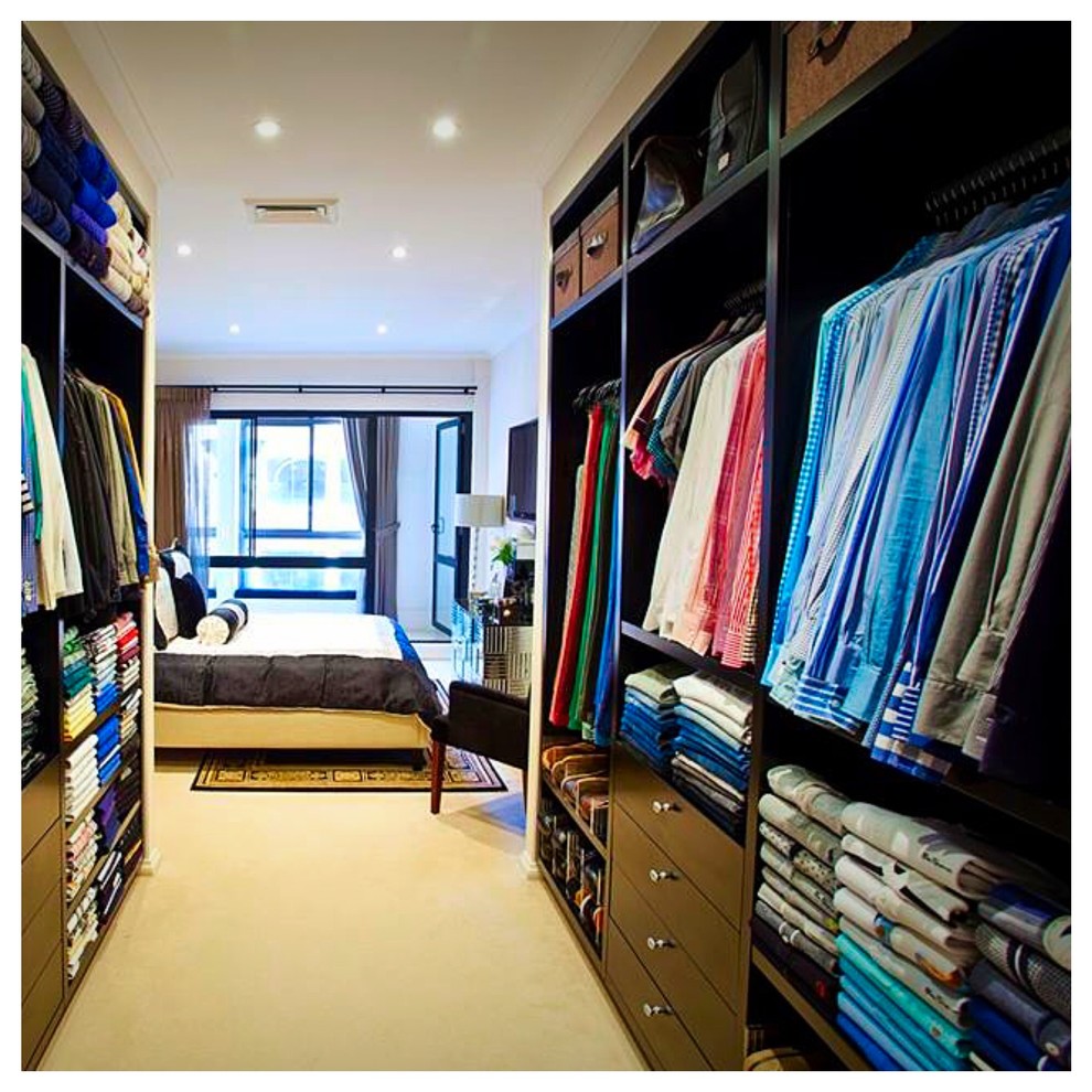 Design ideas for a large modern men's walk-in wardrobe in Sydney with open cabinets, black cabinets and carpet.