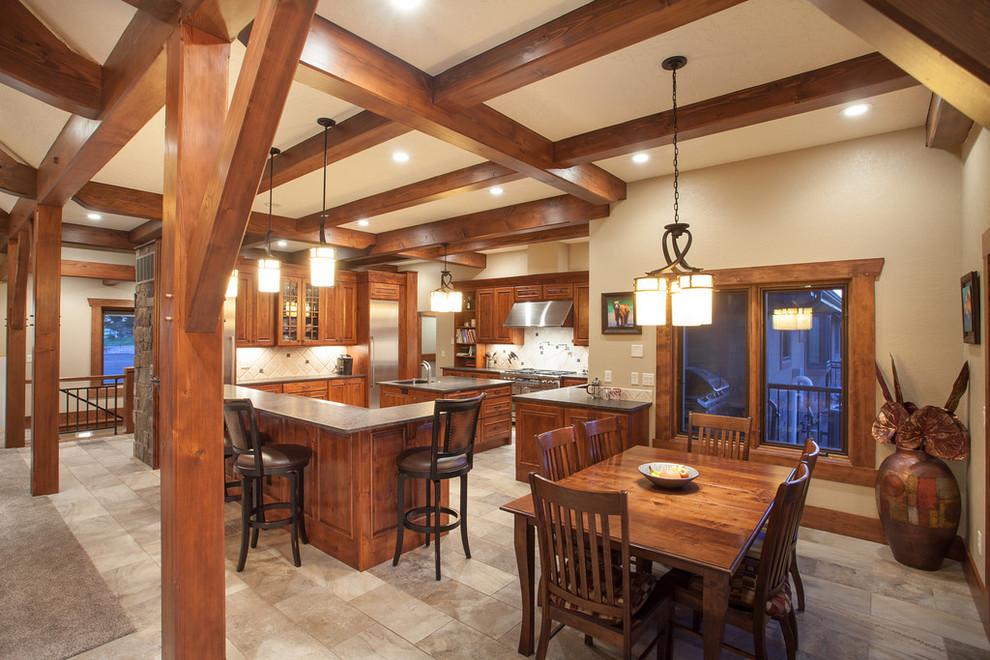 Open concept kitchen - large rustic u-shaped ceramic tile open concept kitchen idea in Denver with an undermount sink, recessed-panel cabinets, medium tone wood cabinets, granite countertops, beige backsplash, ceramic backsplash, stainless steel appliances and two islands