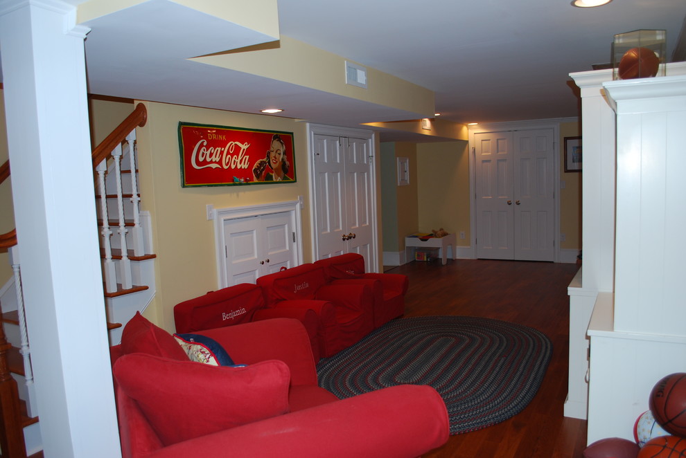 Large traditional basement in New York with yellow walls and medium hardwood floors.
