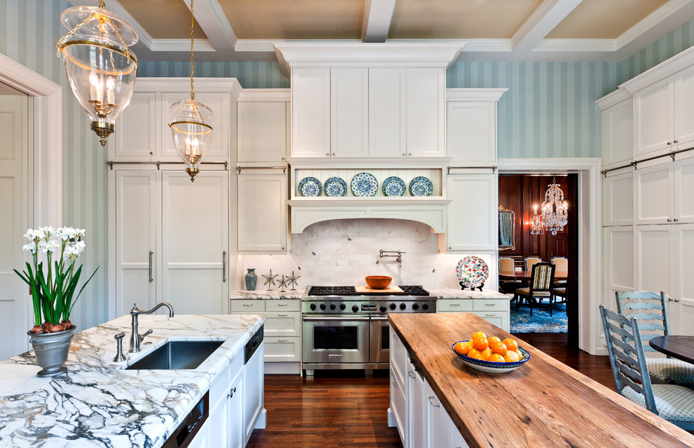 Traditional eat-in kitchen in Philadelphia with wood benchtops, a single-bowl sink, recessed-panel cabinets, white cabinets, white splashback, stone tile splashback and stainless steel appliances.