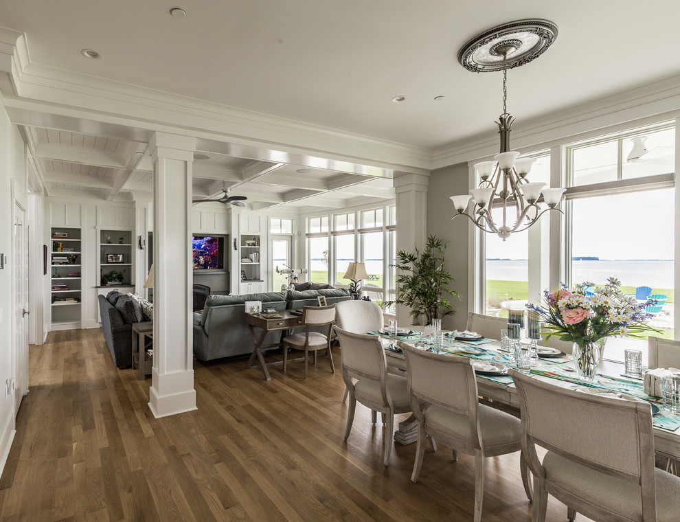 Photo of a beach style dining room in Baltimore with grey walls, dark hardwood floors and brown floor.