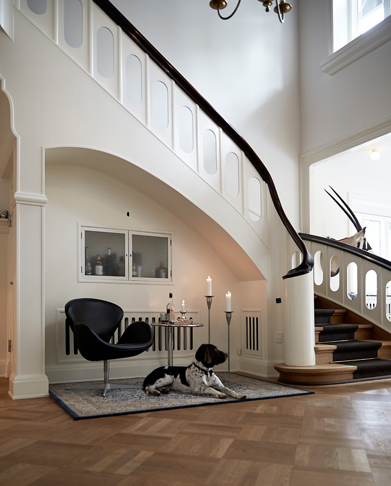 This is an example of a large traditional foyer in Esbjerg with white walls and medium hardwood floors.