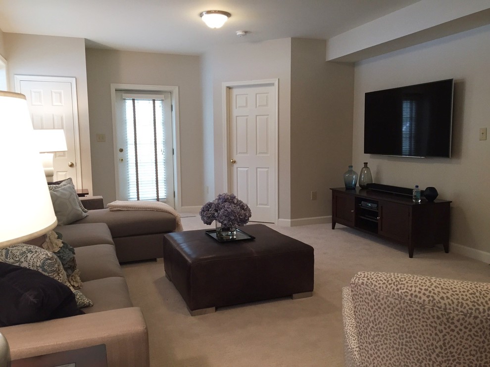 This is an example of a contemporary enclosed family room in DC Metro with grey walls, carpet, a standard fireplace, a brick fireplace surround and a wall-mounted tv.