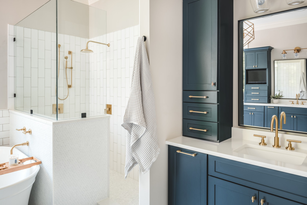 Design ideas for a large modern master bathroom in Charlotte with flat-panel cabinets, blue cabinets, a freestanding tub, white tile, porcelain tile, grey walls, porcelain floors, engineered quartz benchtops, white floor, white benchtops, a double vanity and a built-in vanity.