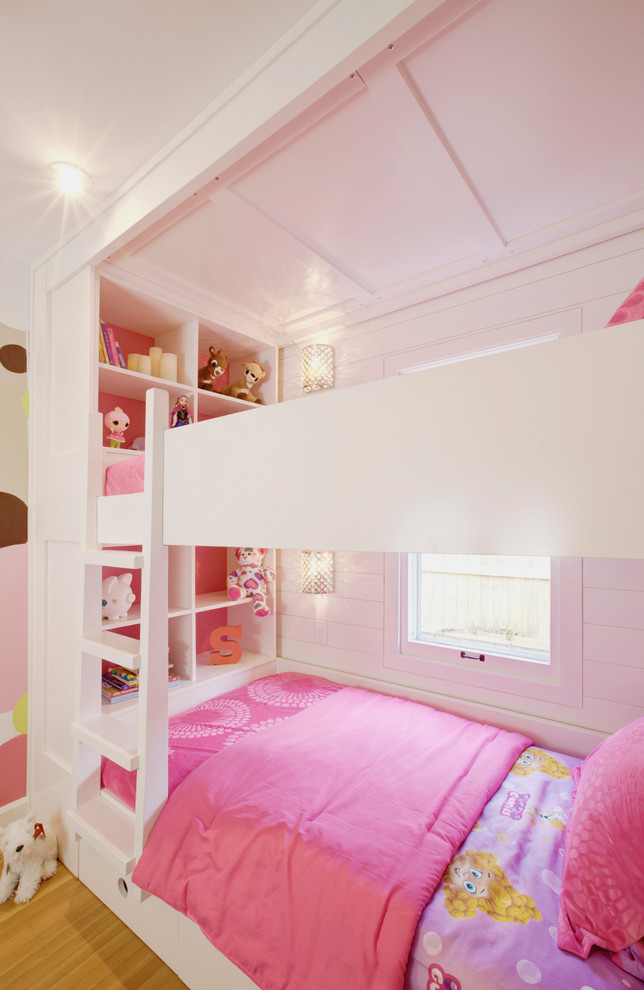 This is an example of a small transitional kids' bedroom for kids 4-10 years old and girls in Indianapolis with light hardwood floors and white walls.