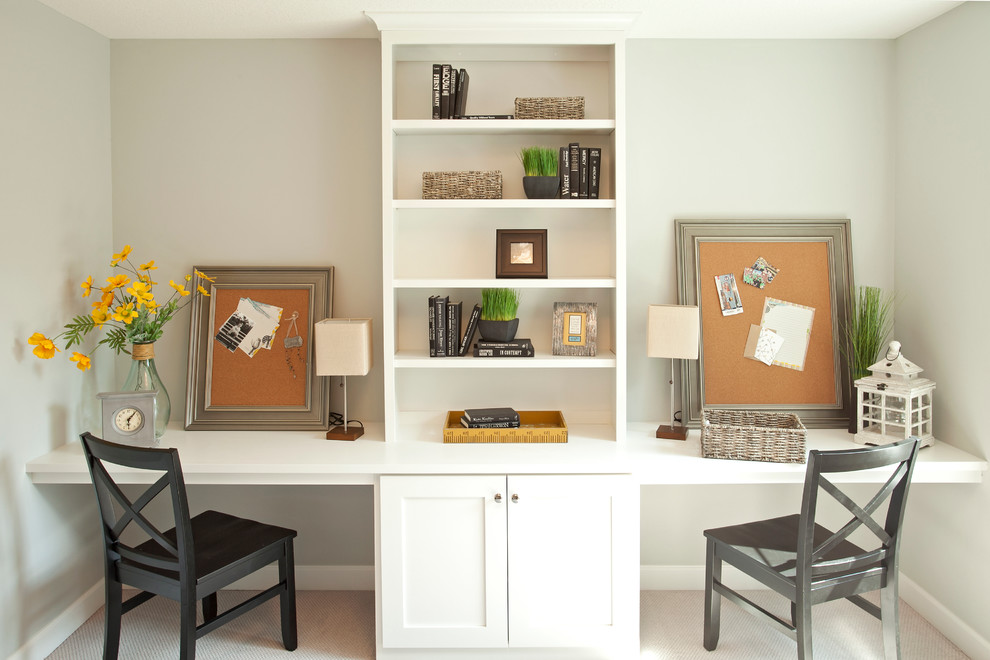 This is an example of a transitional home office in Minneapolis with carpet.