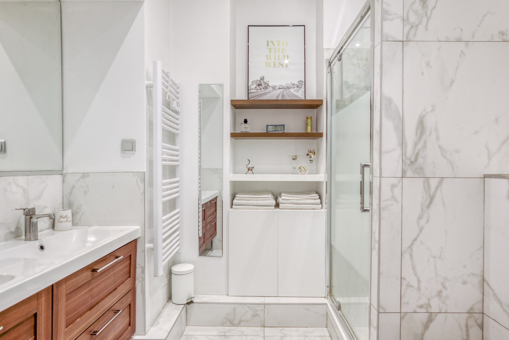 Photo of a contemporary bathroom in Nice with shaker cabinets, medium wood cabinets, an alcove shower, white tile, white walls, an integrated sink, white floor, white benchtops and a double vanity.
