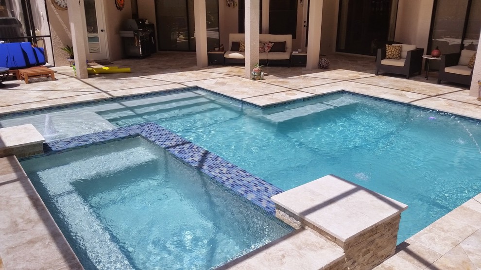 Design ideas for a large modern backyard custom-shaped lap pool in Tampa with a hot tub.
