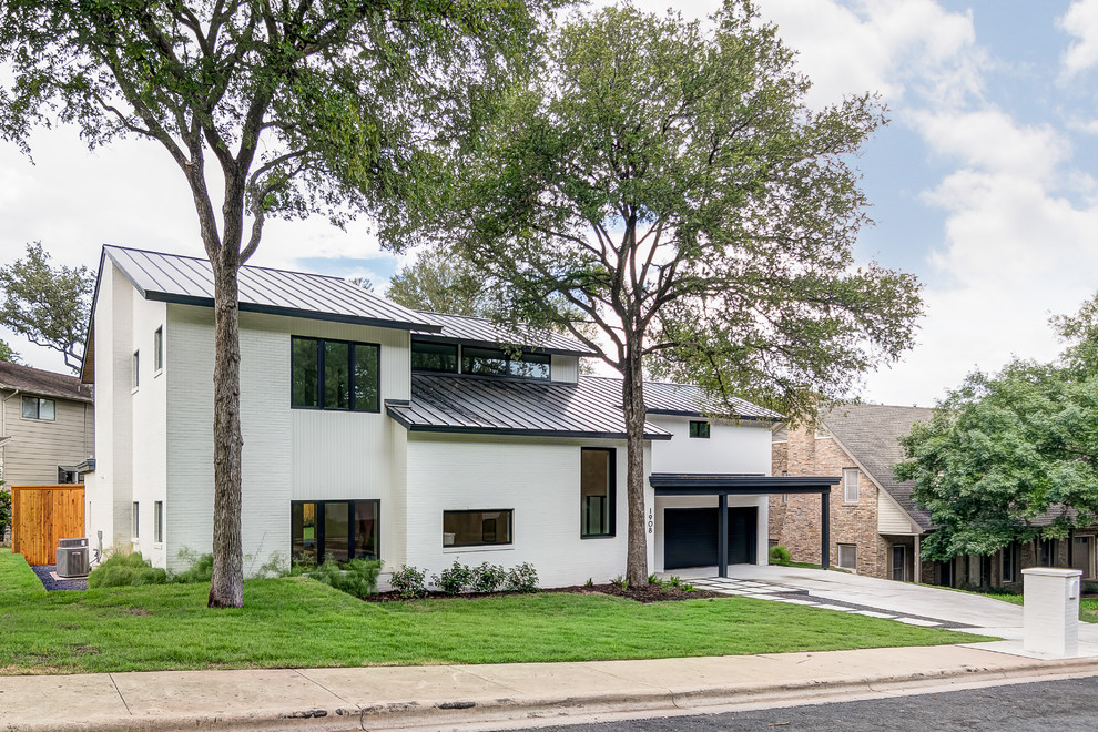 Mid-sized contemporary two-storey white house exterior in Austin with a gable roof, a metal roof and mixed siding.