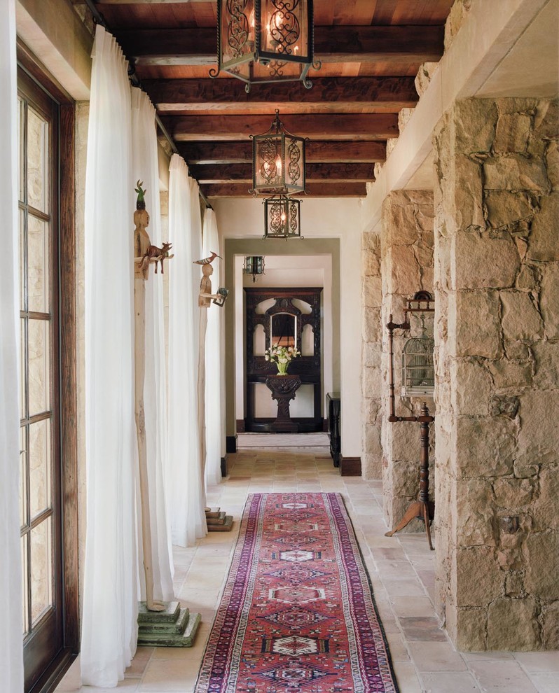 Photo of a mid-sized mediterranean hallway in Orange County with white walls and slate floors.