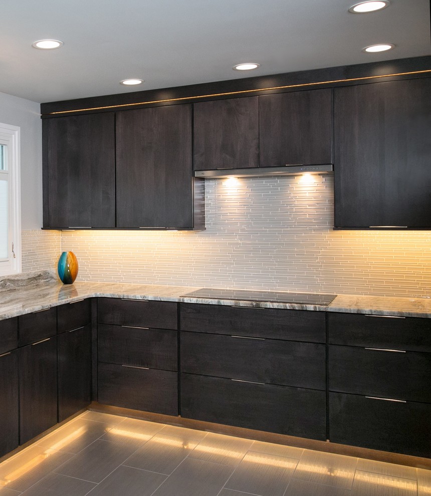 Inspiration for a small modern u-shaped separate kitchen in Philadelphia with an undermount sink, flat-panel cabinets, dark wood cabinets, quartzite benchtops, white splashback, glass tile splashback, stainless steel appliances, porcelain floors and brown floor.