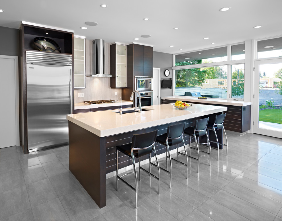 Contemporary kitchen in Edmonton with stainless steel appliances and grey floor.