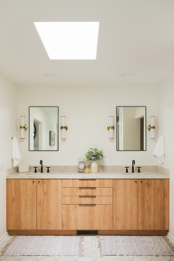Large beach style master bathroom in Santa Barbara with flat-panel cabinets, medium wood cabinets, a freestanding tub, a double shower, a two-piece toilet, gray tile, ceramic tile, white walls, cement tiles, a drop-in sink, quartzite benchtops, white floor, a hinged shower door and beige benchtops.