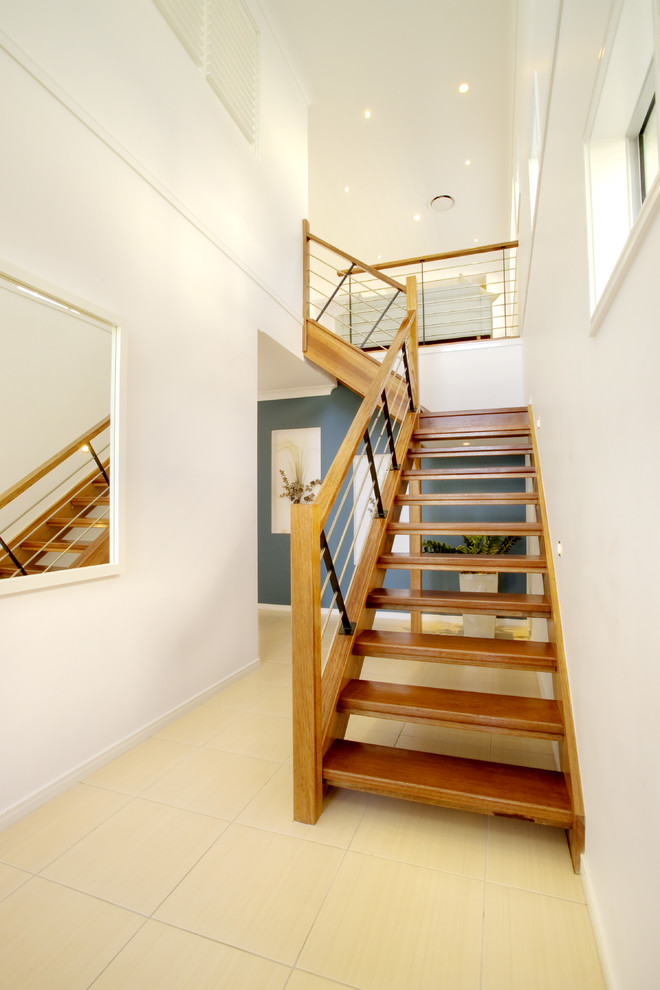 Photo of a contemporary wood l-shaped staircase in Brisbane with open risers and mixed railing.