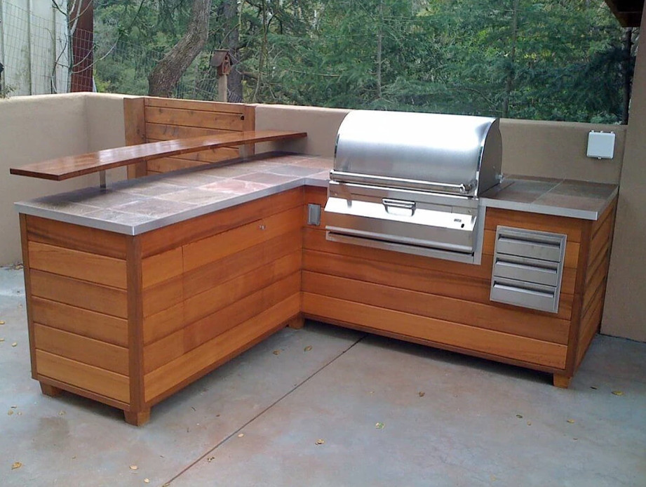 Photo of a mid-sized traditional backyard patio in Boston with an outdoor kitchen, no cover and concrete slab.