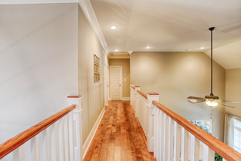 Photo of a mid-sized arts and crafts hallway in Other with grey walls and medium hardwood floors.