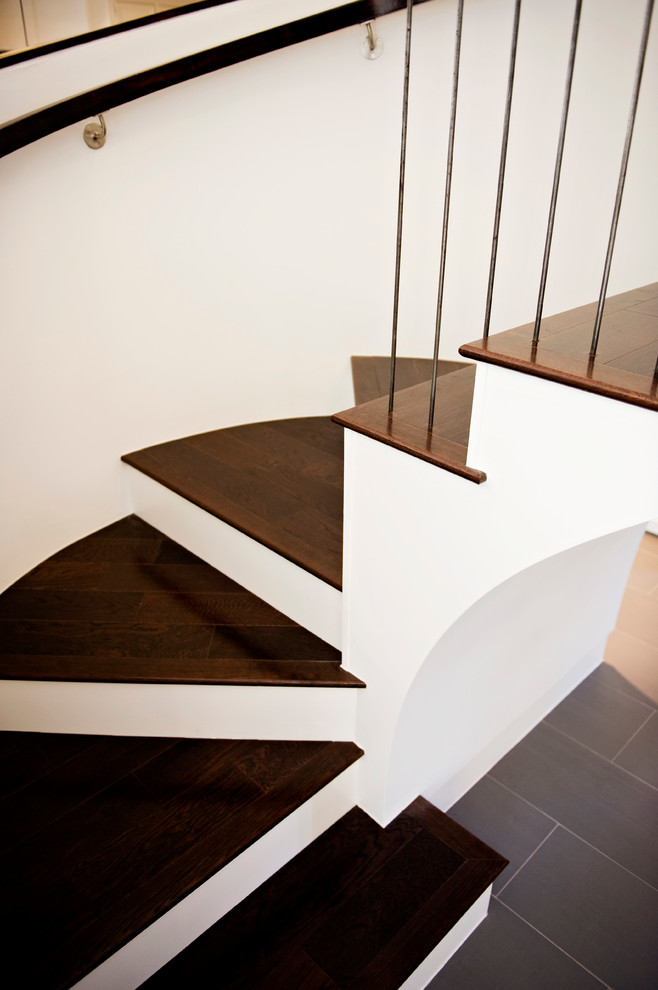 Mid-sized modern wood curved staircase in Austin with wood risers.