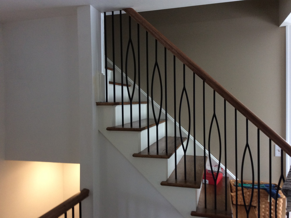 This is an example of a mid-sized arts and crafts wood straight staircase in Detroit with wood risers and mixed railing.