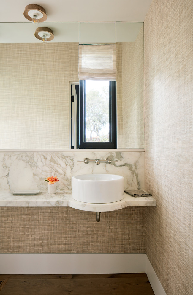 Photo of a country powder room in San Francisco with white tile, marble, beige walls, a vessel sink, marble benchtops, white benchtops and medium hardwood floors.