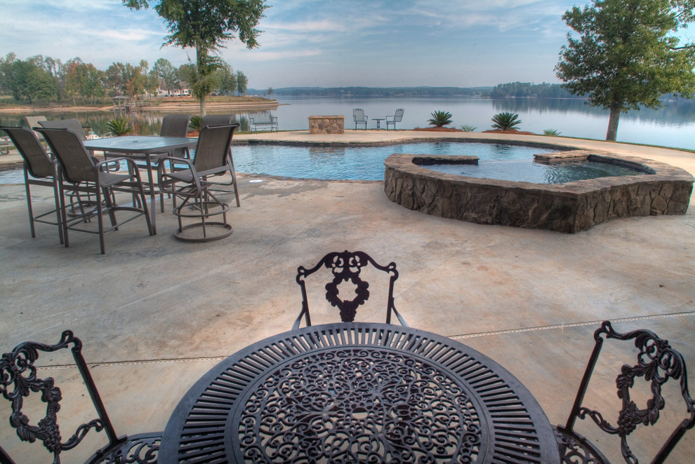 Example of a large backyard stone and custom-shaped natural hot tub design