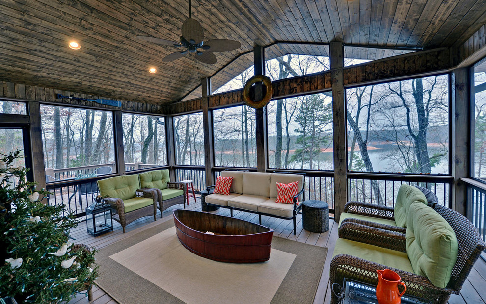 Inspiration for a large arts and crafts backyard screened-in verandah in Atlanta with decking and a roof extension.