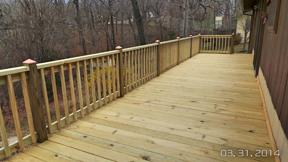 Example of a mid-sized backyard deck design with decking and no cover