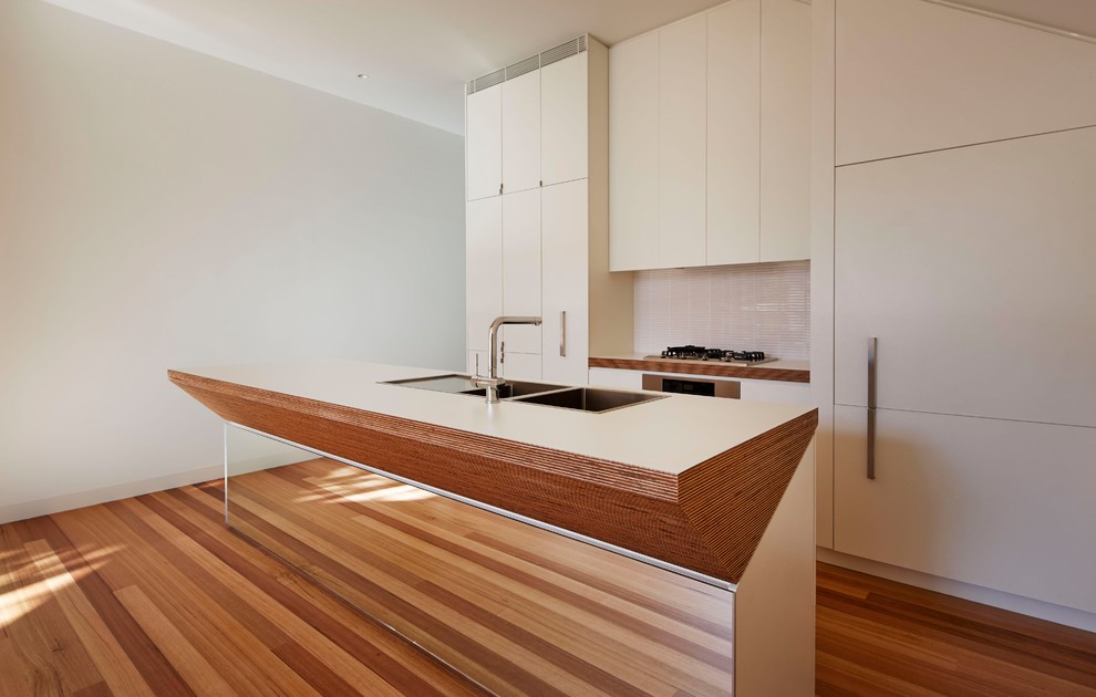 Design ideas for a modern eat-in kitchen in Melbourne with louvered cabinets and with island.