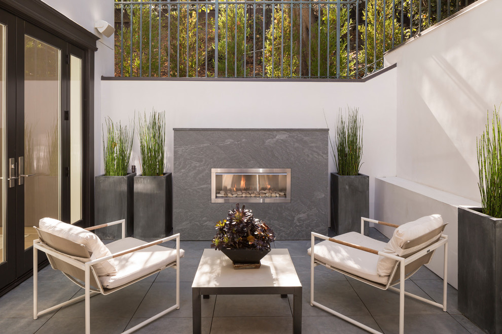 Contemporary backyard patio in San Francisco with no cover and with fireplace.