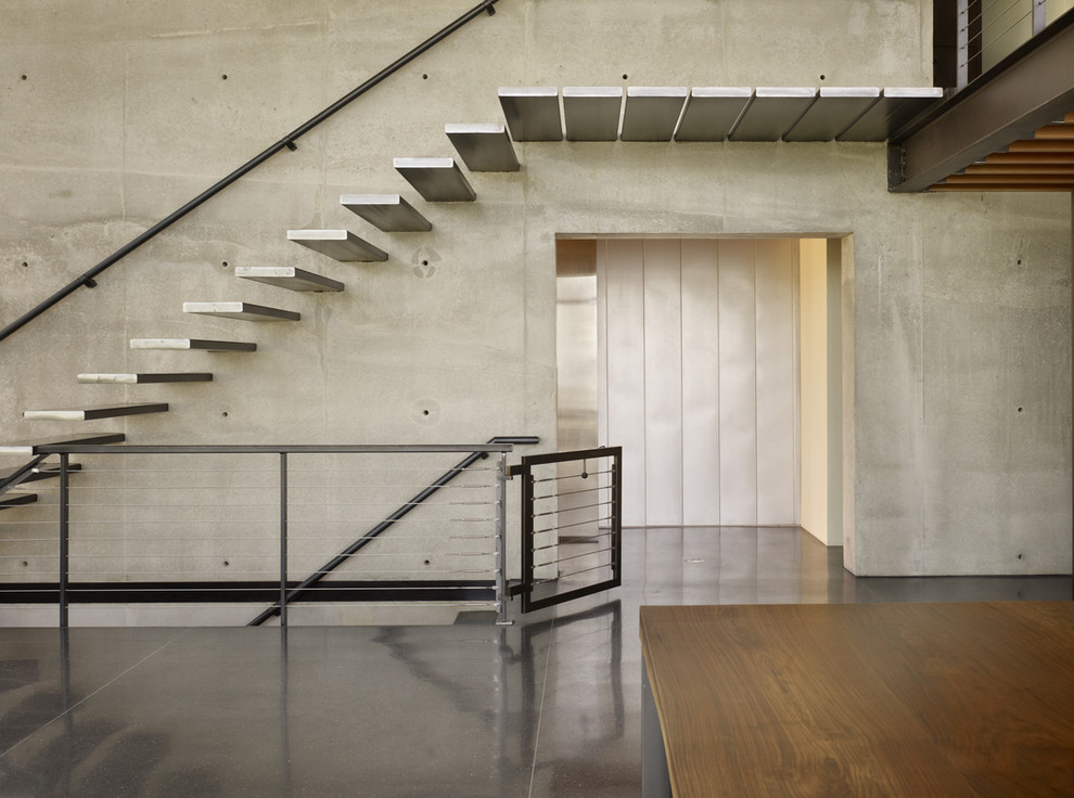 Industrial metal floating staircase in Seattle with open risers.