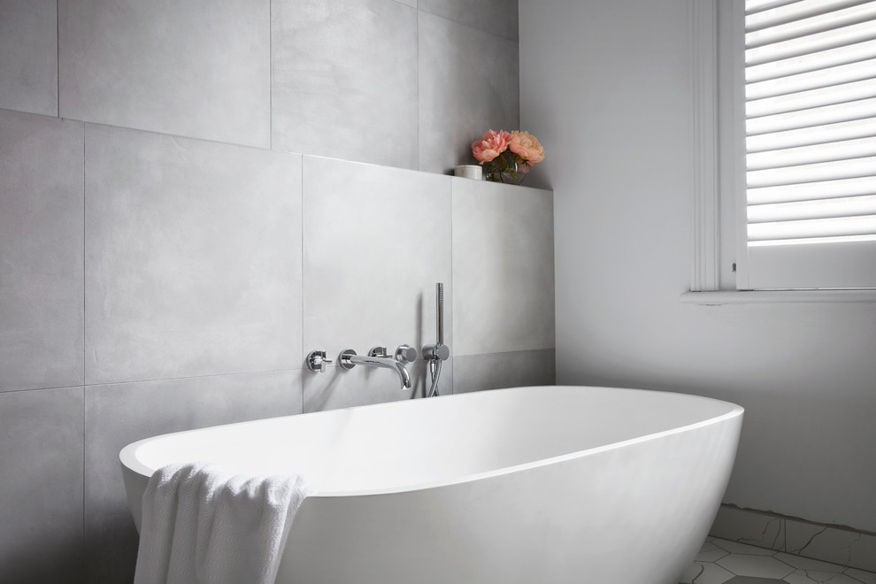 Design ideas for a large contemporary master bathroom in Melbourne with flat-panel cabinets, light wood cabinets, a freestanding tub, an open shower, gray tile, white tile, mosaic tile, white walls, mosaic tile floors, a vessel sink and solid surface benchtops.
