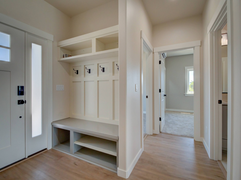 Photo of a mid-sized transitional mudroom in Other with white walls, laminate floors, a single front door, a blue front door and beige floor.