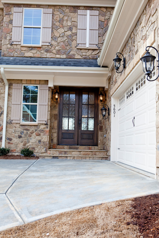 Inspiration for a mid-sized country two-storey beige exterior in Raleigh with stone veneer.