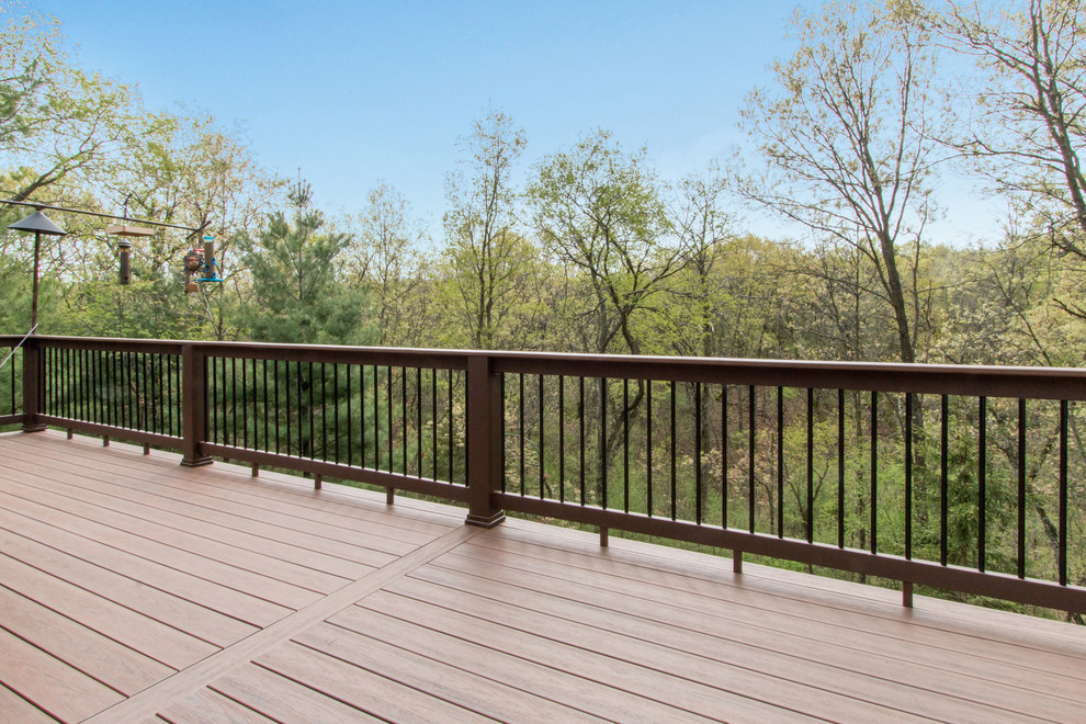 Deck - huge rustic backyard deck idea in Milwaukee with no cover