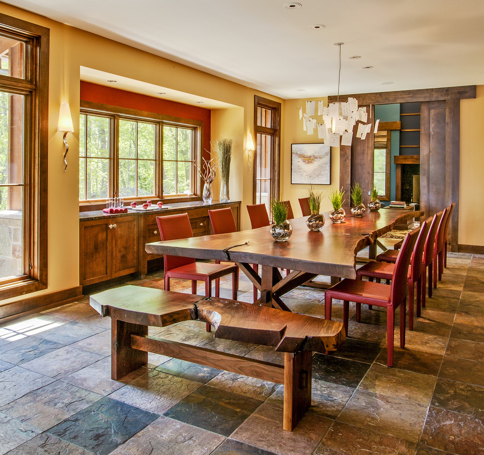 Design ideas for a country dining room in Milwaukee with yellow walls and slate floors.