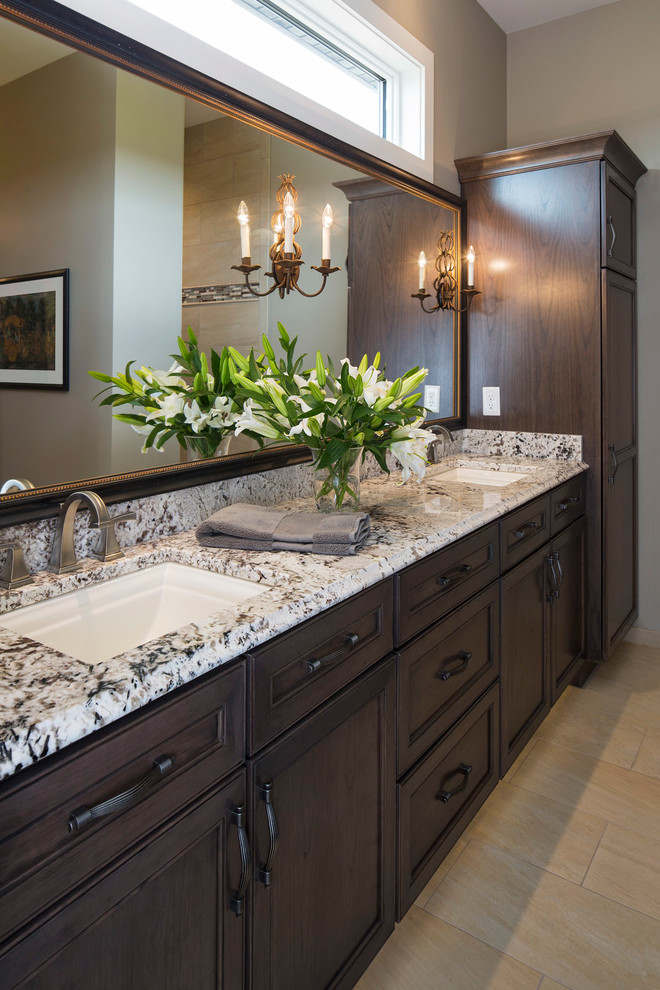 Inspiration for a traditional bathroom in Minneapolis with an undermount sink, recessed-panel cabinets, dark wood cabinets and beige walls.