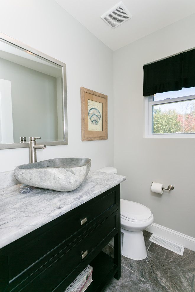 Photo of a small contemporary powder room in St Louis with open cabinets, black cabinets, ceramic tile, grey walls, ceramic floors, a vessel sink, quartzite benchtops and gray tile.