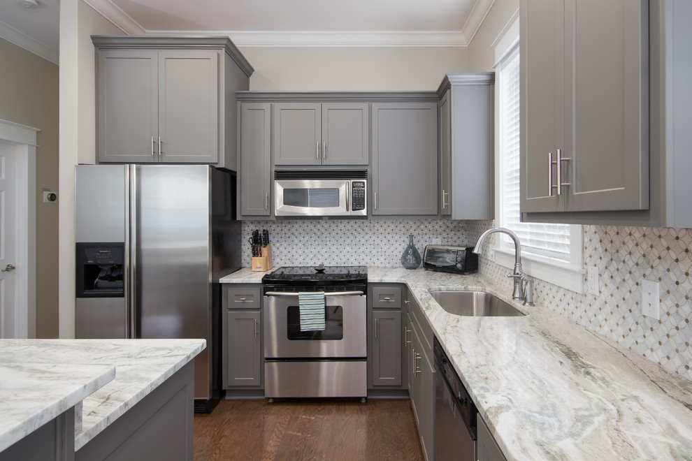 Mid-sized transitional l-shaped eat-in kitchen photo in Miami with an undermount sink, shaker cabinets, gray cabinets, stainless steel appliances and an island