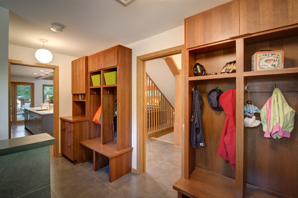 This is an example of a midcentury mudroom in Minneapolis with white walls and ceramic floors.