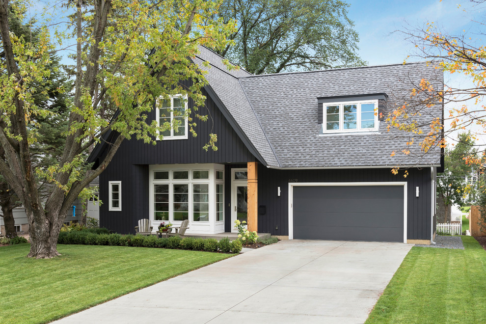 Design ideas for a mid-sized scandinavian two-storey black exterior in Minneapolis with concrete fiberboard siding and a gable roof.