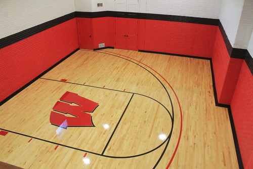 Small indoor basketball court with Wisconsin "W" on floor