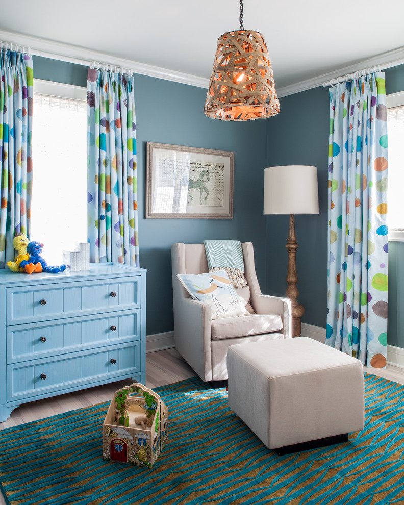 Nursery - transitional gender-neutral light wood floor nursery idea in New York with blue walls