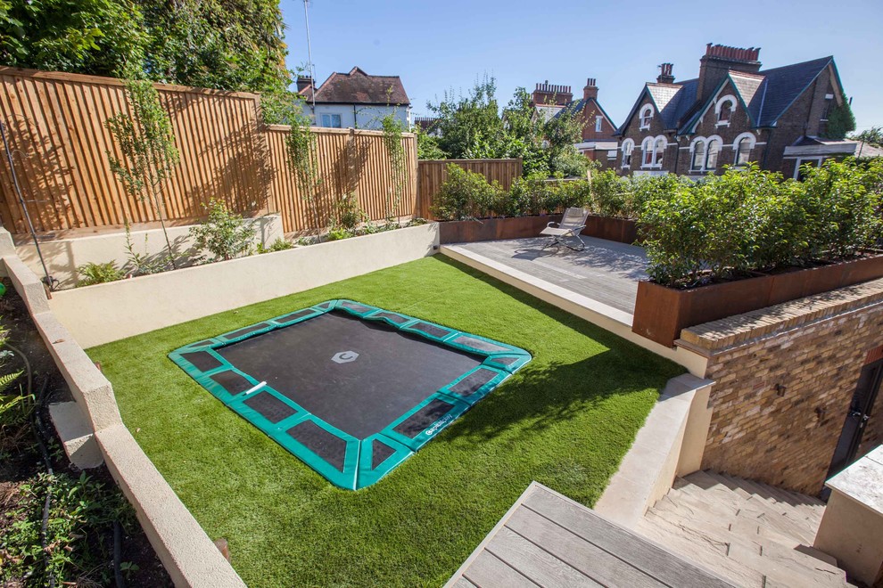 Inspiration for a mid-sized contemporary backyard garden in Hampshire with decking.