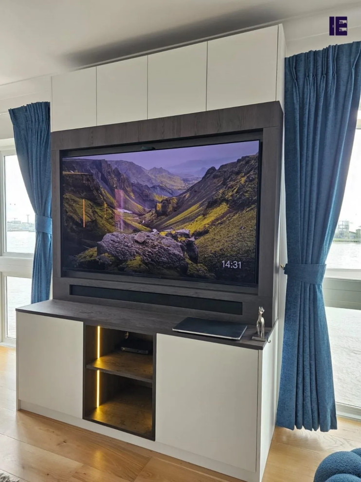 Inspiration for a large modern open concept family room in London with a built-in media wall.