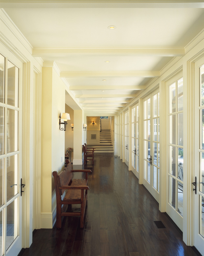 Inspiration for a traditional hallway in San Francisco with white walls, dark hardwood floors and brown floor.