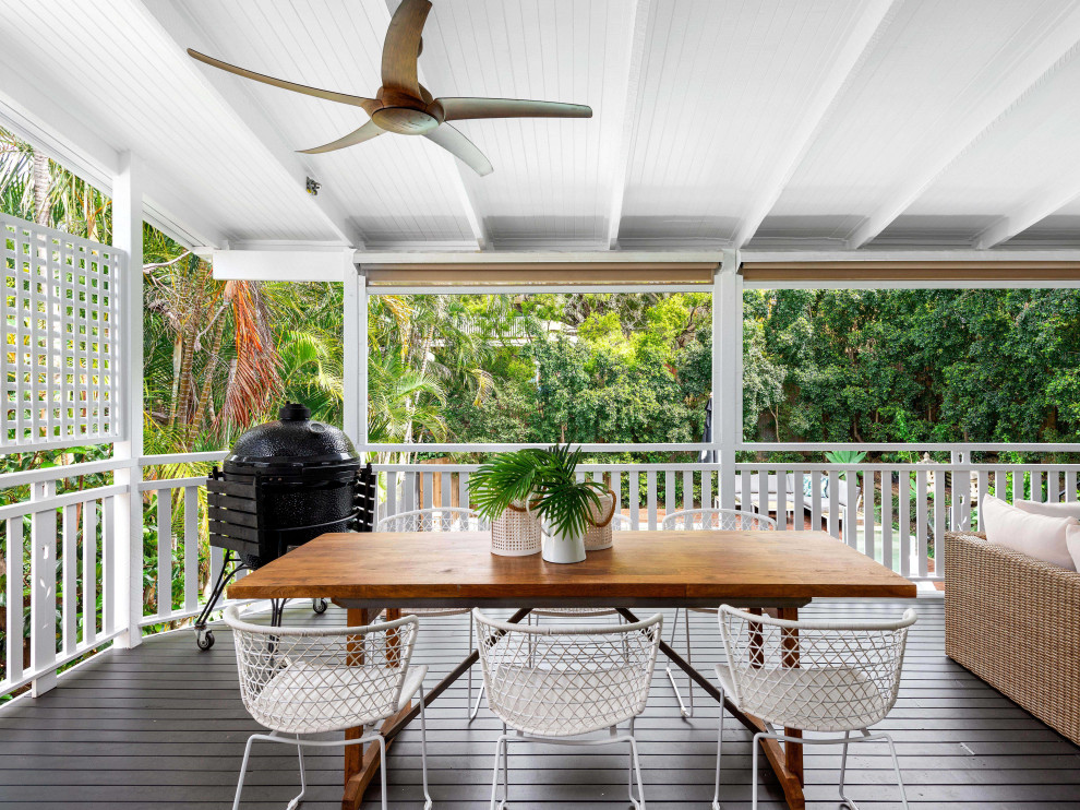 Photo of a mid-sized beach style backyard and first floor deck in Brisbane with a pergola and wood railing.