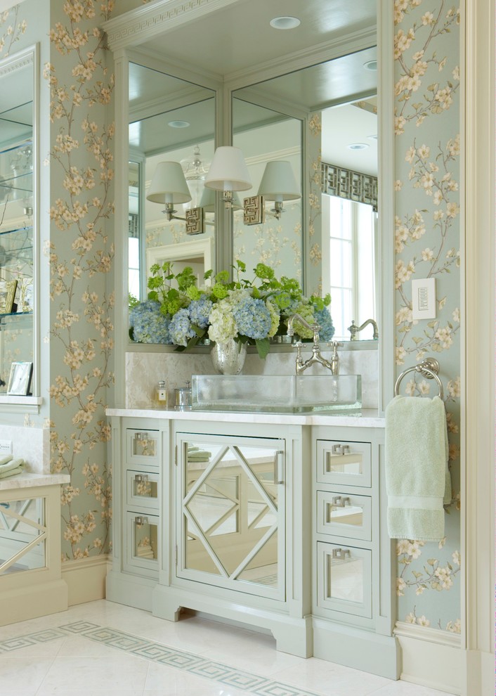 Inspiration for a large contemporary master bathroom in New York with glass-front cabinets, green cabinets, multi-coloured walls, porcelain floors, a vessel sink, marble benchtops and beige floor.