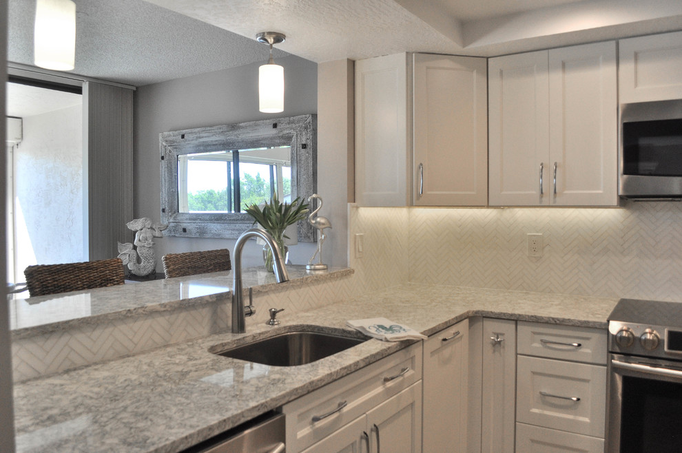 Inspiration for a mid-sized transitional u-shaped eat-in kitchen remodel with an undermount sink, shaker cabinets, white cabinets, quartz countertops, white backsplash, marble backsplash, stainless steel appliances and no island